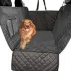 Golden retriever resting on a quilted black pet seat cover in a vehicle, showcasing comfort for pets during travel, ideal for automotive repair and tuning services at Reflex Tuning in New Hampshire.