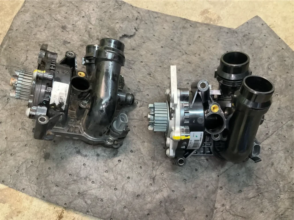 Audi VW Service Two black automotive water pumps with gears and hoses are placed side by side on a gray mat; one appears used and worn, while the other looks new and clean. Reflex Tuning, Hookett NH