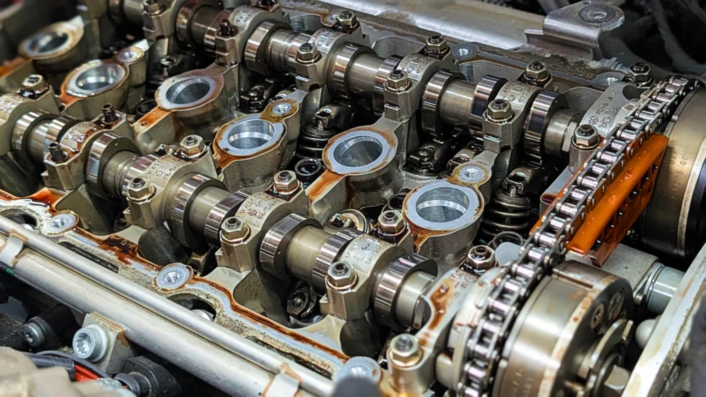 Audi VW Service Close-up view of an exposed internal combustion engine, highlighting metal camshafts, valve springs, and timing chain components—mechanical details often scrutinized when diagnosing VW engine problems. Reflex Tuning, Hookett NH