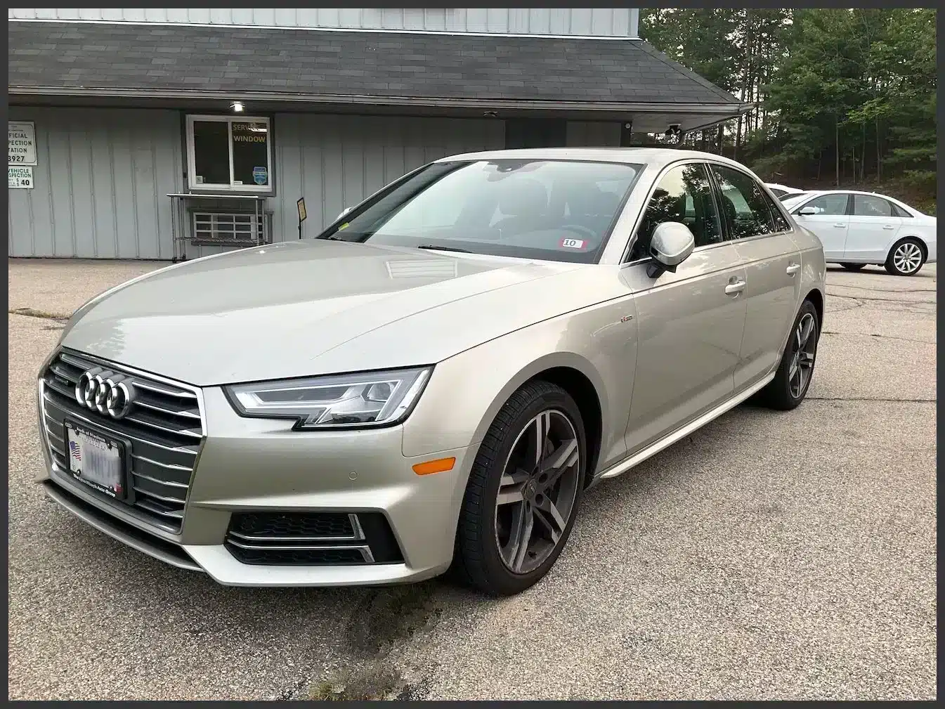 Silver Audi A4 sedan parked outside Reflex Automotive shop in Hooksett NH