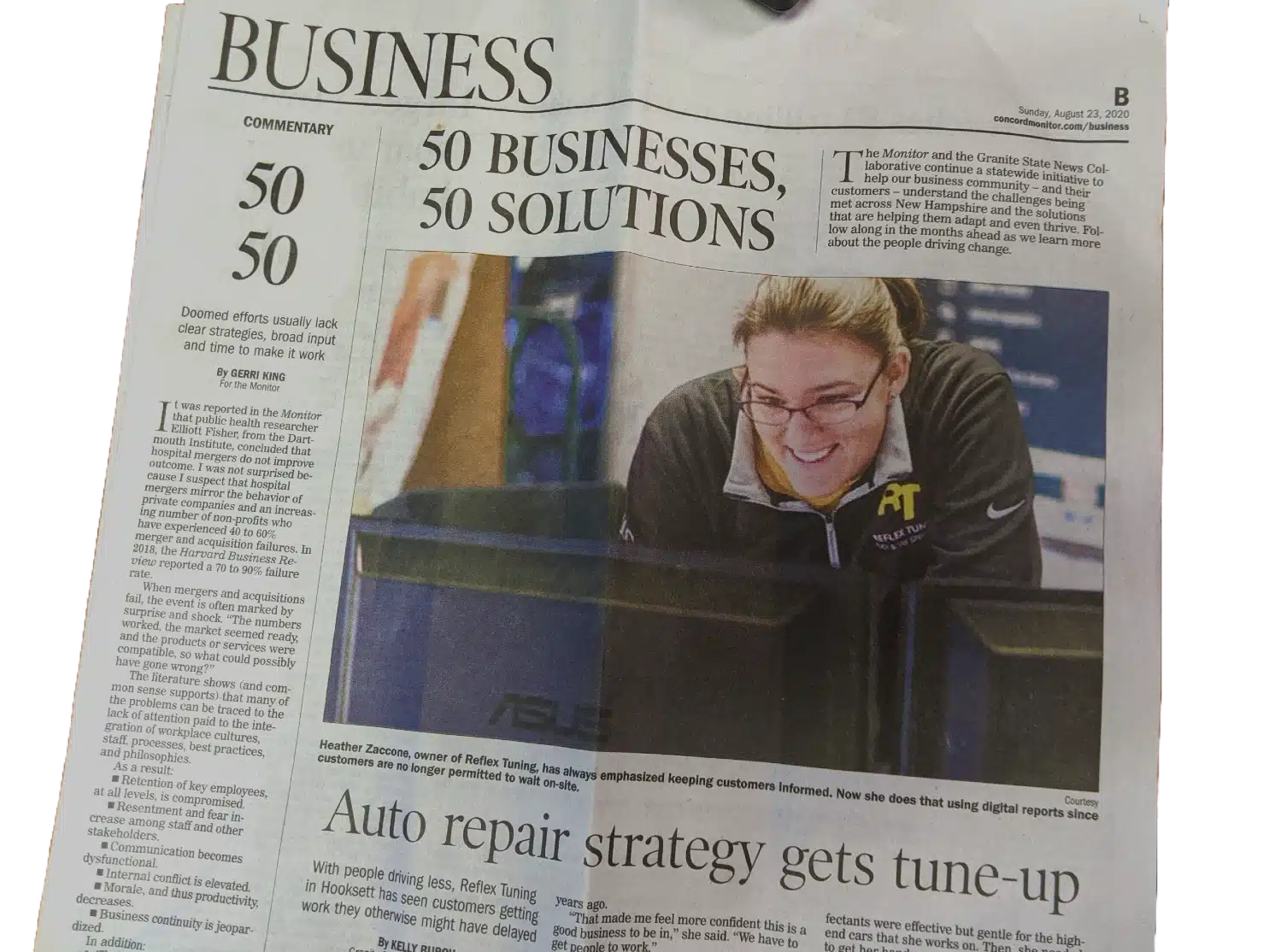Audi VW Service A newspaper business section features the headline 50 BUSINESSES, 50 SOLUTIONS with a photo of a smiling woman wearing glasses and a black jacket, working at a computer. Other articles and commentary appear around the image. Reflex Tuning, Hookett NH