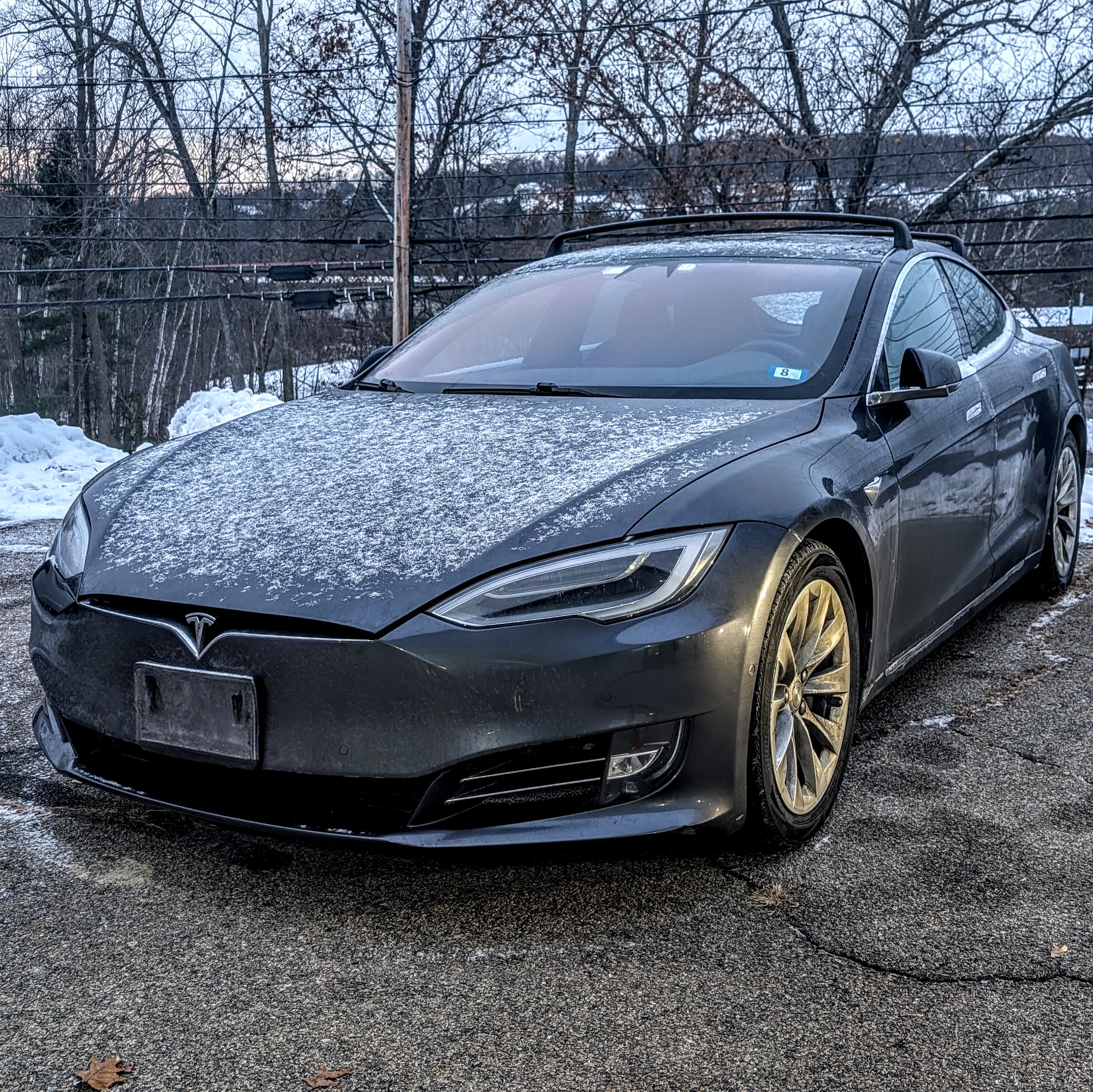 Tesla Model S with a light layer of snow parked in New Hampshire