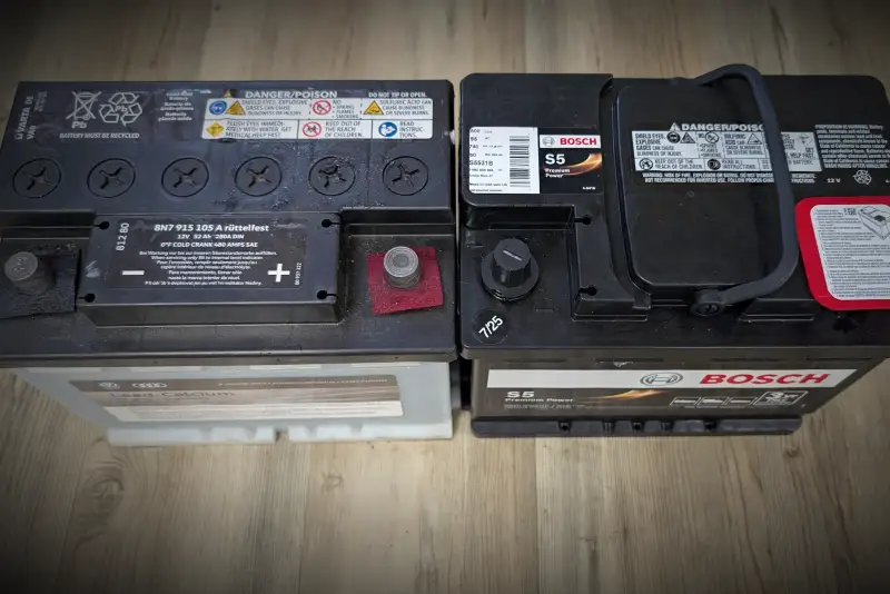 OEM Audi battery next to Bosch replacement battery at Reflex Automotive Hooksett NH