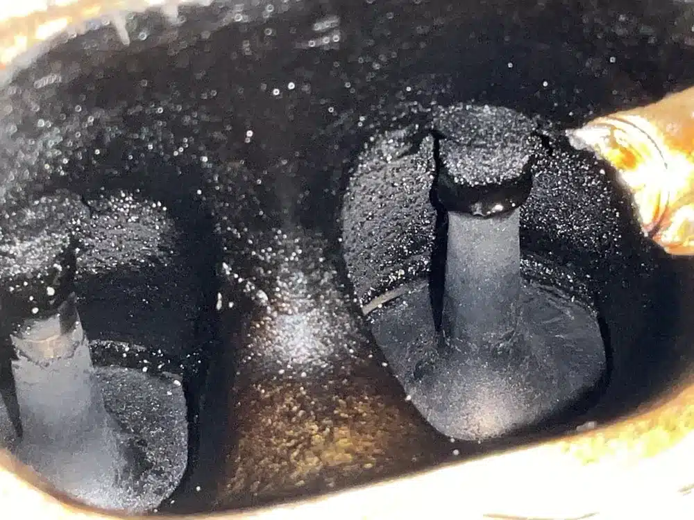 Carbon buildup on intake valves of a 2021 Audi Q5 before walnut blast cleaning