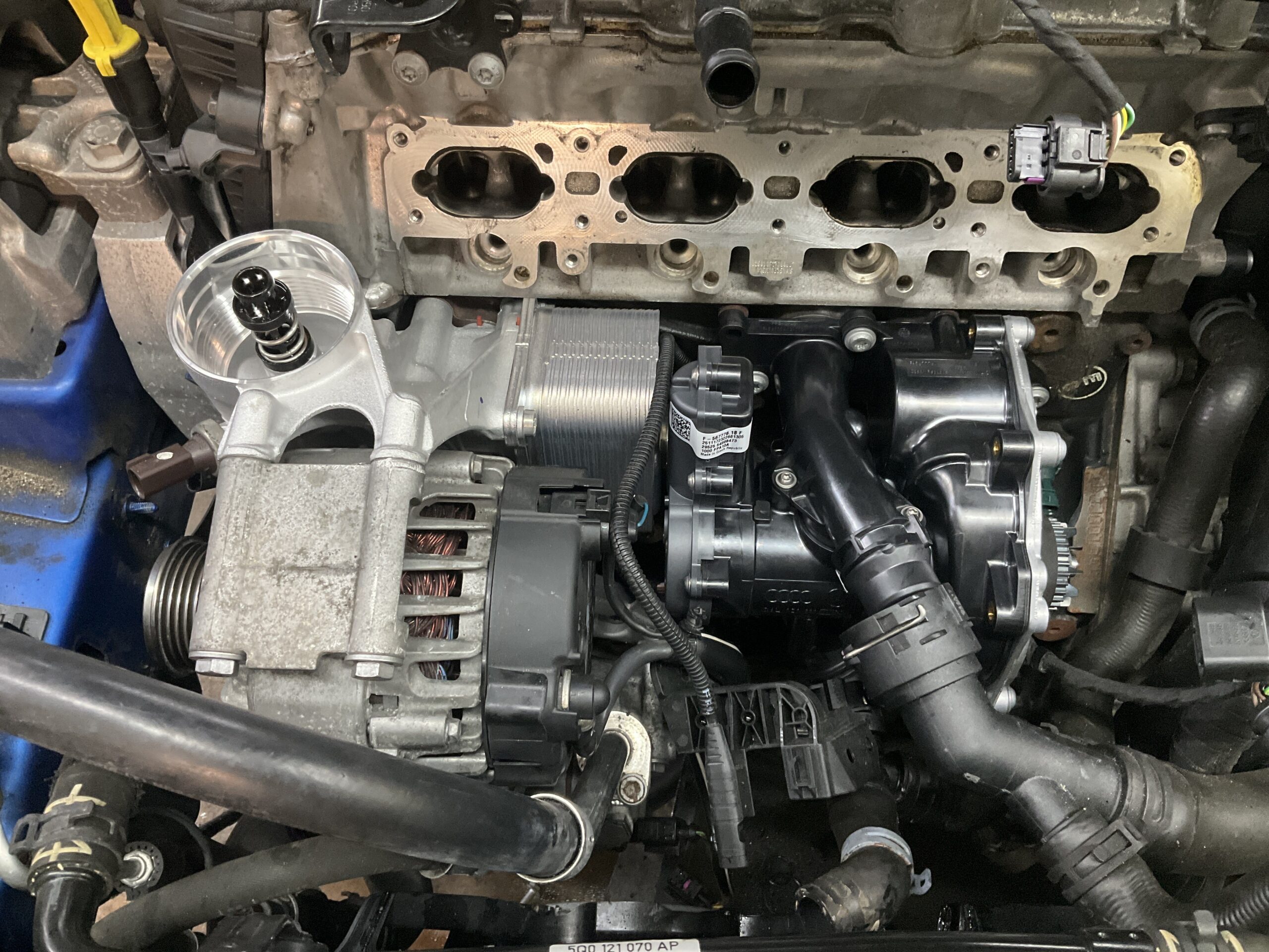 2018 Audi S3 engine bay fully reassembled with new water pump thermostat oil cooler and bracket at Reflex Automotive
