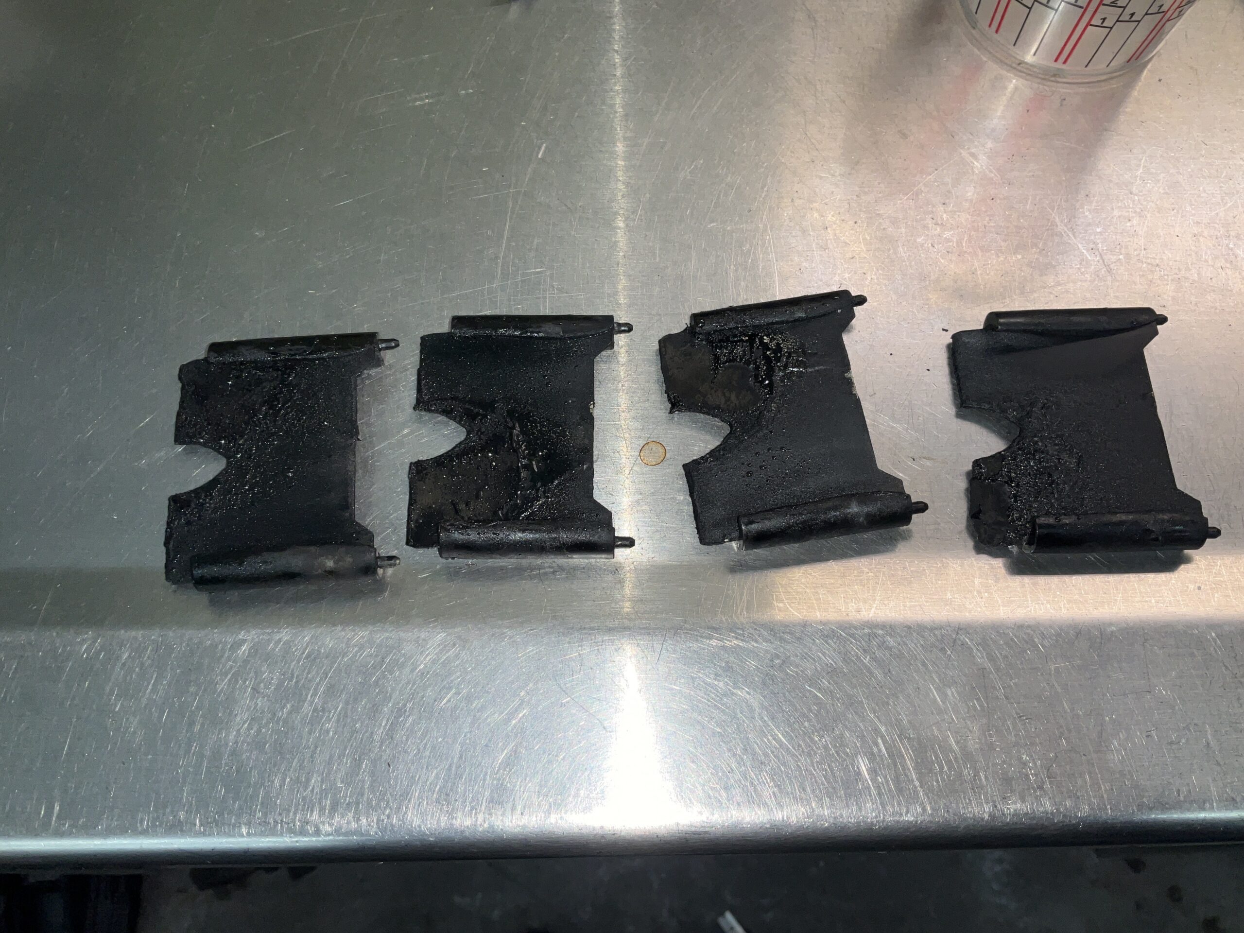 Carbon-caked intake manifold tumble flaps from a 2018 Audi S3 before cleaning at Reflex Automotive